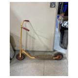 This vintage children's kick scooter features a