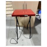Folding metal table with electrical outlet