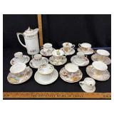 teapot with assorted cups & saucers & creamer &