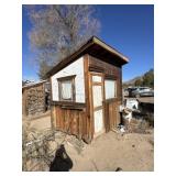 Small storage shed on skids, with contents.