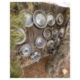 misc hub caps.   Hanging on a wall.   Buyer to