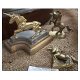 Three small brass unicorn figurines