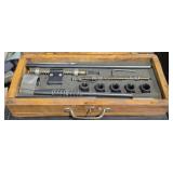 Wooden box contains a vintage automotive valve