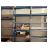 Three blue metal shelves with some content