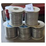 five rolls of solid solder wire