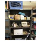 Metal shelf with contents and paint supplies