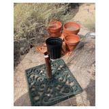 Umbrella, pedestal, and some flower planters