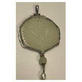 This is a sterling silver pendant featuring a