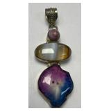 This is a multi-gemstone pendant featuring a pink