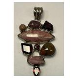 This is a sterling silver multi-gemstone pendant