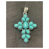 This is a turquoise and sterling silver cross