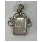 This is a sterling silver pendant featuring a