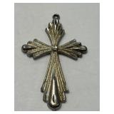 This is a sterling silver cross pendant with a