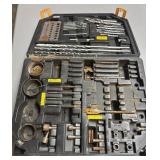 Plastic tool chest containing drill, bits, whole