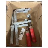 Box containing two large clamps
