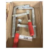 Box containing two large clamps