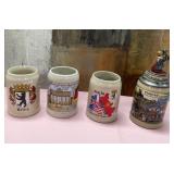 71 - FOUR COLLECTIBLE BEER STEINS