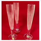 513 - THREE CLEAR GLASS CHAMPAGNE FLUTES (T106)