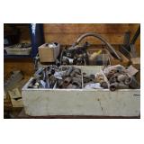 Red table with large assortment of pipe fittings