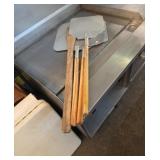 3 Pizza peels and a mixing paddle