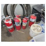 Four large fire extinguishers outside full