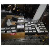 Two trays of new valve and other parts