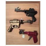 Daisy Buck Rogers XZ-31 Rocket Pop pistol, Daisy Buck Rogers Automic Pistol, and Wyandotte Ray Gun