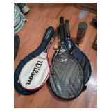 5 tennis rackets in cases with tennis balls