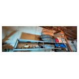 Two Shelves of Items: Tires, Lumber, Toolboxes, and Other Items
