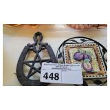 TWO IRON TRIVETS