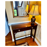 Mahogany Console Table With Brass Drawer Pulls and Decorative Table Lamp