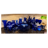 Cobalt Blue Glassware Including Pitchers, Vases, and Bottles