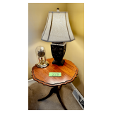 Round Wooden Pedestal Table with Carved Base, Waltham Quartz Dome Clock, and Decorative Lamp