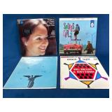 Four Vinyl Records Across Various Genres