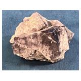 Raw Mineral Specimen on Blue Background