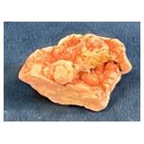 Raw Orange Mineral Specimen on Blue Background