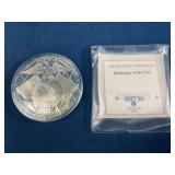 Commemorative Coin Featuring Eagle, Globe, and $10