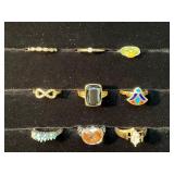 Nine Mixed Metal Rings with Various Designs and Ge