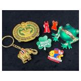 Various Pins and a Keychain Featuring Gold and Ena