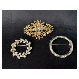 Three Costume Brooches in Gold, Silver, and Rhines