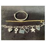 Three Bracelets in Mixed Metals Featuring Charms a