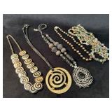 Five Statement Necklaces Featuring Various Materia