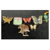 Seven Animal-Themed Brooches in Various Materials