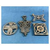 Four Cast Iron Trivets in Various Shapes and Desig