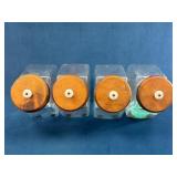 Four Glass Storage Jars with Wooden Lids