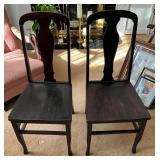 Two Dark Wood Dining Chairs with Shaped Backrests