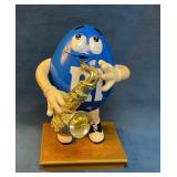 Blue M&M Character Figure Holding a Saxophone on G