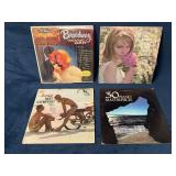 4 Assorted Vinyl Records with Sleeves