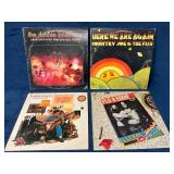 Four Vinyl Record Albums Featuring Classic Rock Ar