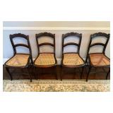 Four Dark-Wood Chairs with Caned Seats and Carved